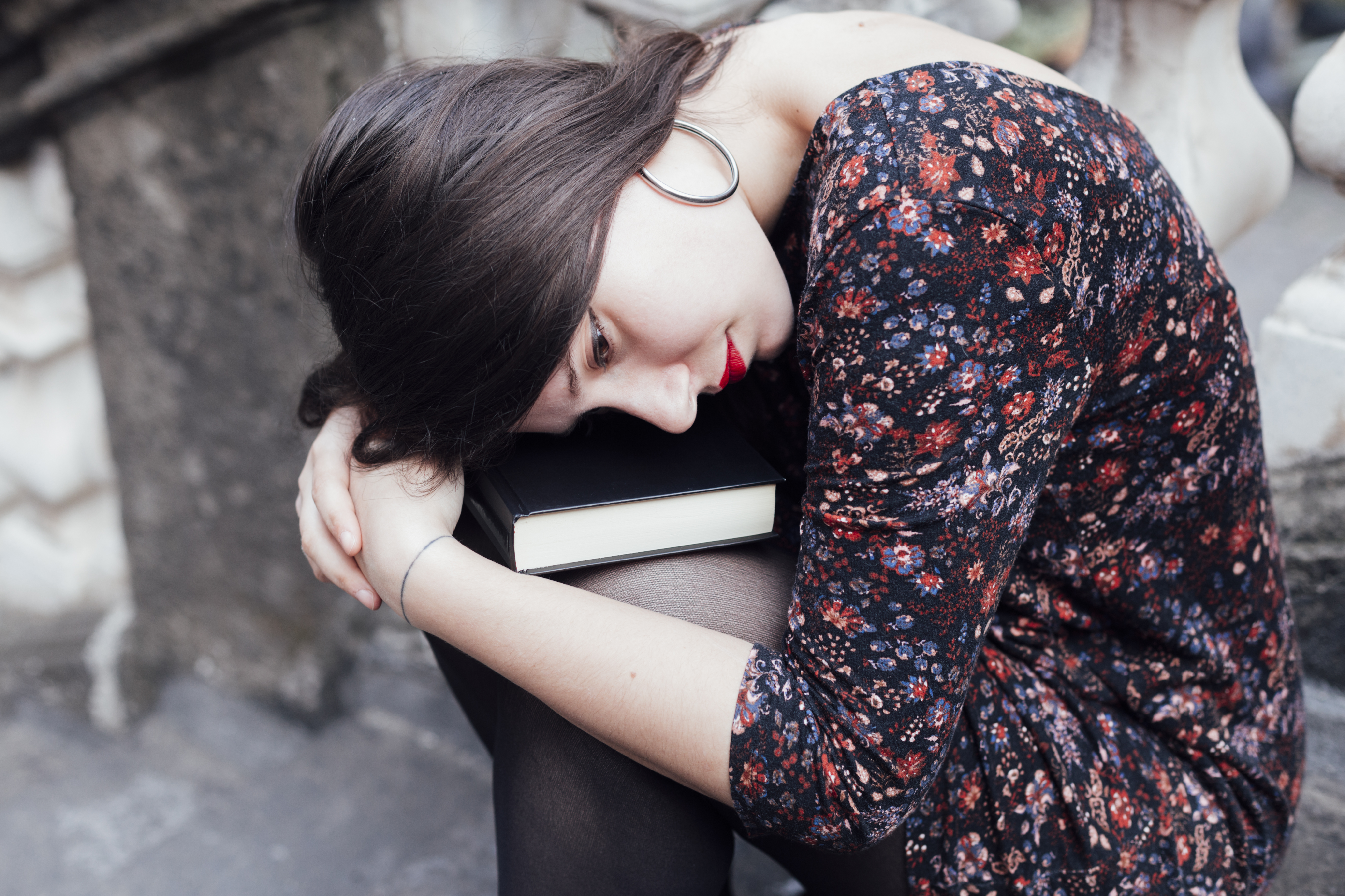 Person resting beside a closed book
